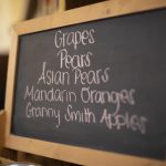 chalkboard sign in dining hall with fruit options