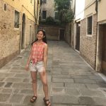 Deanna Han in courtyard between buildings