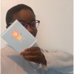 Oluyemisi holding a blue card