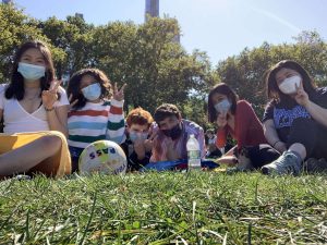 Lucy & 4 friends on grass with masks