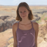Siena Swift from waist up in desert landscape