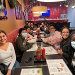students around long table in restaurant