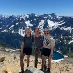 Three students with snowy mountains in background
