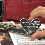 hand holding heart object with words about creativity and joy